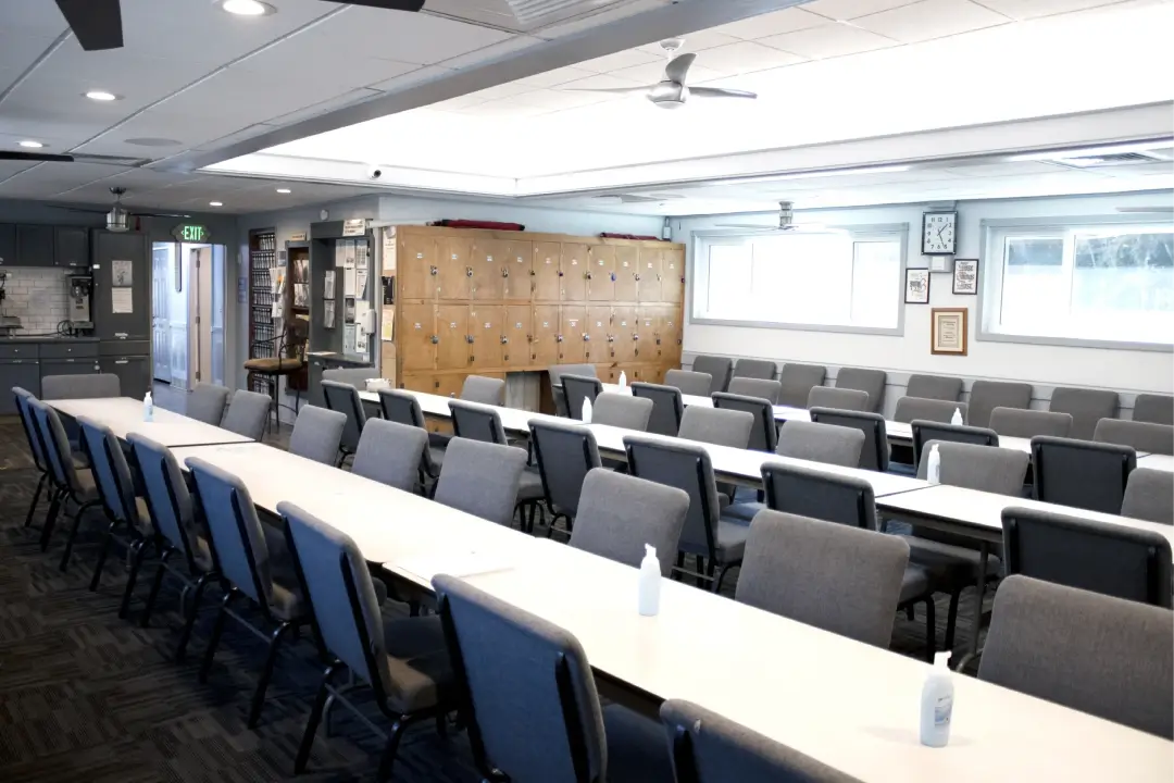 A well-lit room with a long table, chairs A well-lit room with a long table, chairs